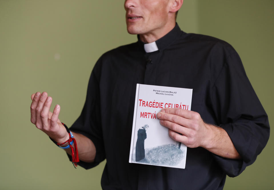 Roman Catholic priest Michal Lajcha holds his book "The Tragedy of Celibacy - The Death of Wife," during an interview with The Associated Press in Klak, Slovakia, Monday, Sept. 17, 2018. Lajcha is challenging the Roman Catholic Church’s celibacy rules in a rare instance of dissent in the conservative religious stronghold in central and eastern Europe. (AP Photo/Petr David Josek)
