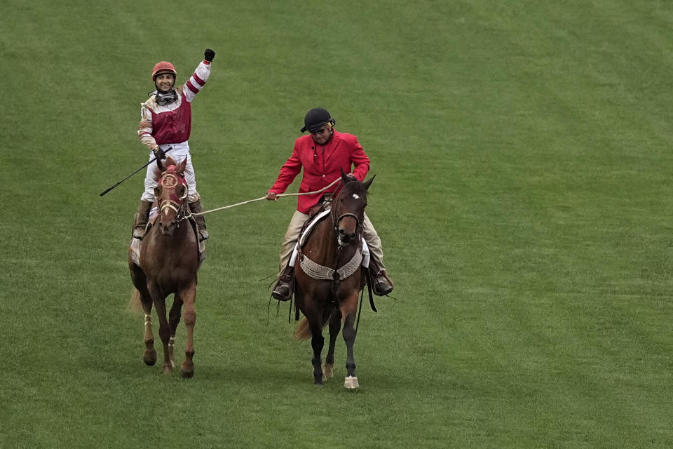 Rich Strike, with Sonny Leon aboard, is led to the winner's circle after winning the 148th running of the Kentucky Derby horse race at Churchill Downs Saturday, May 7, 2022, in Louisville, Ky. (AP Photo/Charlie Riedel)