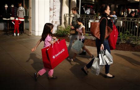 People shop at The Grove mall in Los Angeles in this November 26, 2013 file photo. REUTERS/Lucy Nicholson/Files