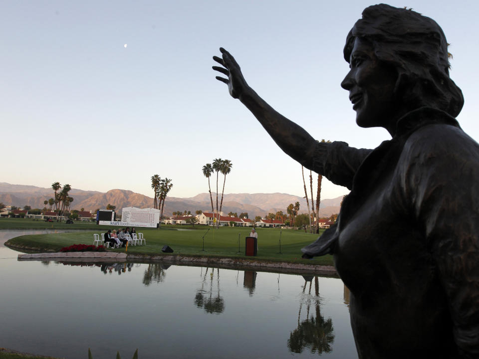 FILE - A statue of actress and long time tournament host Dinah Shore frames LPGA tour chaplain Cris Steven speaking during an Easter sunrise service before the final round of the LPGA Kraft Nabisco Championship golf tournament in Rancho Mirage, Calif., Sunday, April 4, 2010. The major is trying to keep some of the Dinah Shore heritage at its new location north of Houston. (AP Photo/Chris Carlson, File)