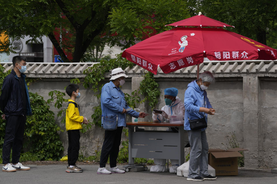 Residents register for mass COVID-19 test on Monday, May 9, 2022, in Beijing. (AP Photo/Ng Han Guan)