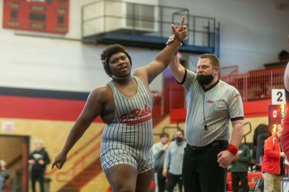 East's Lee Smith, shown getting his hand raised during regionals on Saturday, Feb. 05, 2022. at East High School in Rockford, is 68-10 the last two years as a wrestler and is also expected to be one of the best defensive linemen in the NIC-10 this football season.