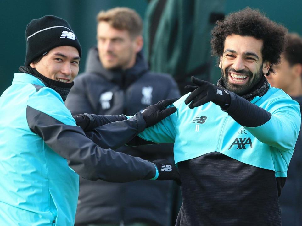 Liverpool's Mohamed Salah jokes with Takumi Minamino: AFP via Getty Images