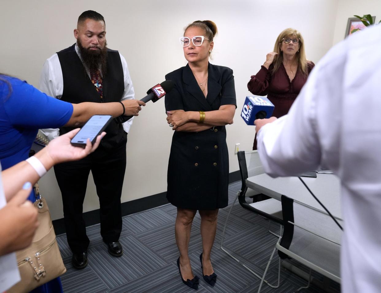 RI Education Commissioner Angélica Infante-Green waits for the first question from members of the press after making a recommendation on whether to return control of Providence schools back to Providence or continue the state's takeover for more time after a meeting of the RI state Council on Elementary and Secondary Education on Thursday evening. Far left is Dr. Javier Montañez, Providence Schools Superintendent and far right is Patricia DiCenso, Chair of RI state Council on Elementary and Secondary Education.