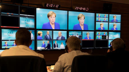 German Chancellor Angela Merkel of the Christian Democratic Union (CDU) is seen on screens at a TV studio during a debate with her challenger, Germany's Social Democratic Party SPD candidate for chancellor Martin Schulz, in Berlin, Germany, September 3, 2017. Herby Sachs/WDR/Handout via REUTERS