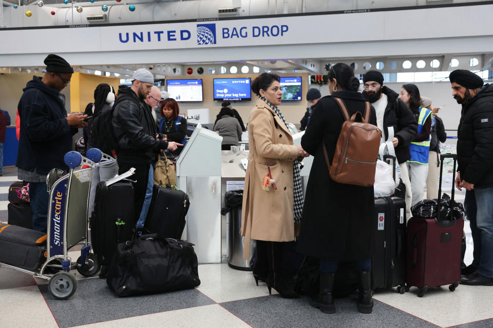 Travelers arrive for flights at O'Hare International Airport in Chicago, on December 22, 2022. A winter weather system bringing snow, high winds, and sub-zero temperatures has wreaked havoc on holiday travel during one of the busiest days of the year for airlines. As of 8:00 AM more than 400 flights out O'Hare had been canceled.<span class="copyright">Scott Olson—Getty Images</span>