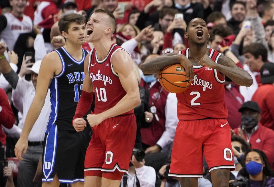 Ohio State's Justin Ahrens (10) and Cedric Russell (2) celebrate against Duke.