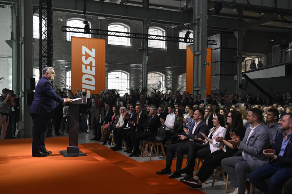 Hungarian Prime Minister and Chairman of Fidesz party Viktor Orban addresses a rally launching the campaign of the party for the European Parliamentary and the local elections in Budapest, Hungary, Friday, April 19, 2024. The inscription reads The peace only! The Fidesz only! Hungarian Prime Minister Viktor Orbán on Friday painted a grim picture of a continent teetering on the edge of armed conflict in a speech opening his party's campaign for European Union elections. He called for a changing of the guard among the bloc's leaders. (Szilard Koszticsak/MTI via AP)