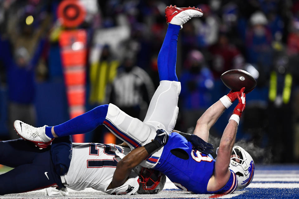 Buffalo Bills tight end Dawson Knox (88) scores a touchdown against New England Patriots safety Adrian Phillips (21) during the first half of an NFL wild-card playoff football game, Saturday, Jan. 15, 2022, in Orchard Park, N.Y. (AP Photo/Adrian Kraus)