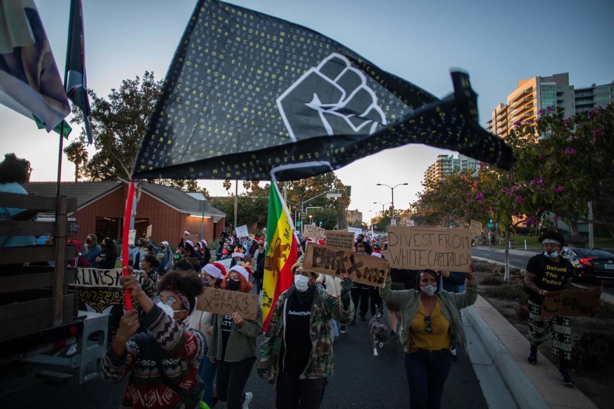 <p>Protesters march through the Marina Del Rey neighbourhood of Los Angeles during a Black Lives Matter rally to demand social justice on December 19, 2020</p> (AFP via Getty Images)