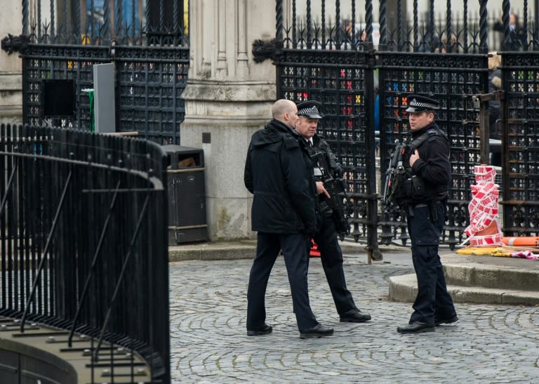 Armed police stand guard at the entrance to the Houses of Parliament which remain closed in central London on March 24, 2017 two days after the March 22 terror attack on the British parliament and Westminster Bridge