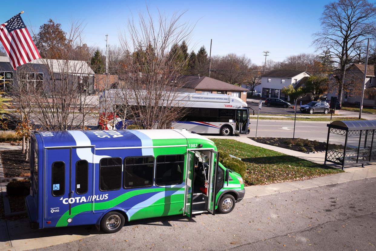 A COTA//Plus micro-transit vehicle next to a regular fixed-route bus.