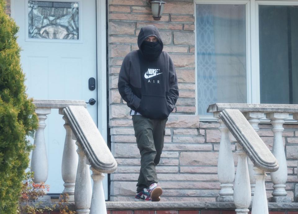 A squatter strolls out of a home at 160th Street in Queens, a $1 million home taken over by a crew that claimed tenant rights. Brigitte Stelzer