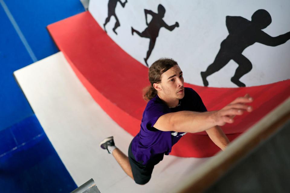 Alex Romer, 17, demonstrates running up an 18-foot wall Wednesday, Aug. 23, 2023 at Mighty Orion Fitness in Orange Park, Fla. A senior at Ridgeview High School, Romer is competing this season on NBC's “American Ninja Warrior."