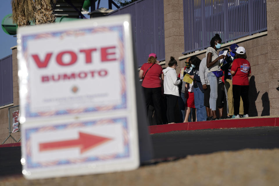 FILE - People wait in line to vote at a polling place on Election Day, Tuesday, Nov. 3, 2020, in Las Vegas. On Friday, Oct. 21, 2022, the Nevada Supreme Court declined to halt a rural Nevada county's plan to begin hand-counting mail-in ballots two weeks before Election Day, but blocked its plan to livestream the counting to ensure that voting results aren't released. (AP Photo/John Locher, File)