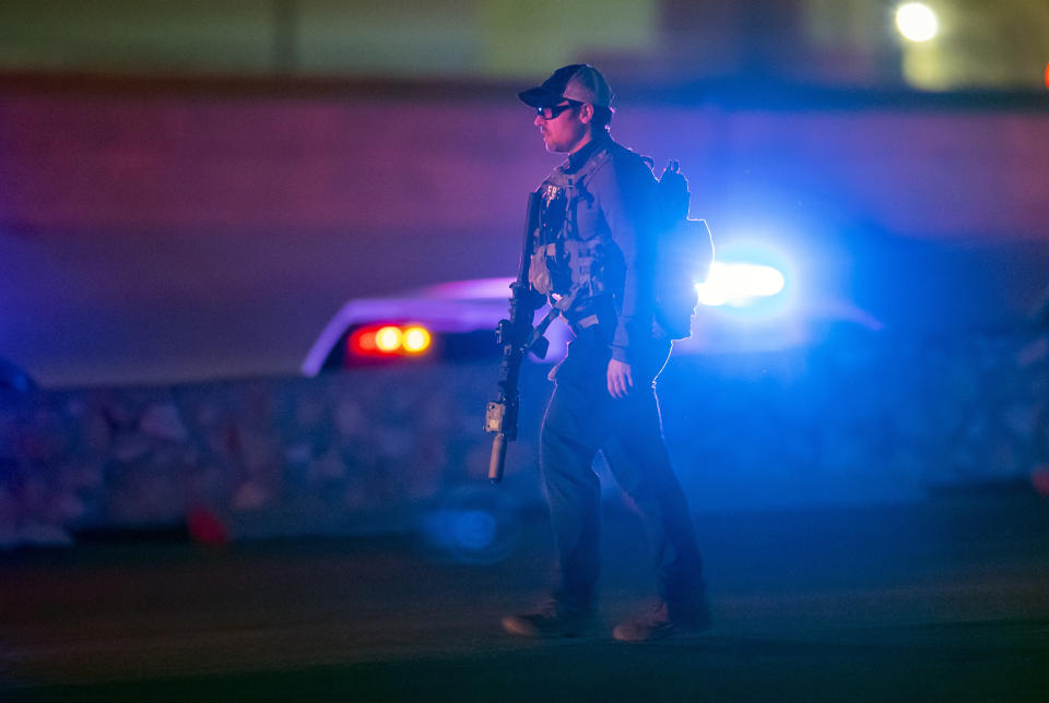 An FBI agent walks outside a shopping mall, Wednesday, Feb. 15, 2023, in El Paso, Texas. Police say one person was killed and three other people were wounded in a shooting at Cielo Vista Mall. One person has been taken into custody, El Paso police spokesperson Sgt. Robert Gomez said. (AP Photo/Andrés Leighton)