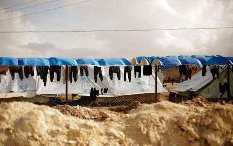 In this March 31, 2019, photo, laundry dries on a chain-link fence at Al-Hol camp, in the section where foreign families from Islamic State-held areas are housed, Hassakeh province, Syria - Credit: Maya Alleruzzo/AP