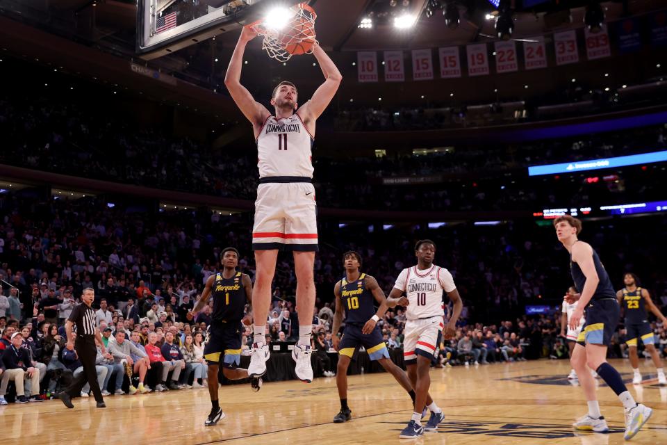 Mar 16, 2024; New York City, NY, USA; Connecticut Huskies forward Alex Karaban (11) dunks against Marquette Golden Eagles guards Kam Jones (1) and Zaide Lowery (10) during the second half at Madison Square Garden. Mandatory Credit: Brad Penner-USA TODAY Sports
