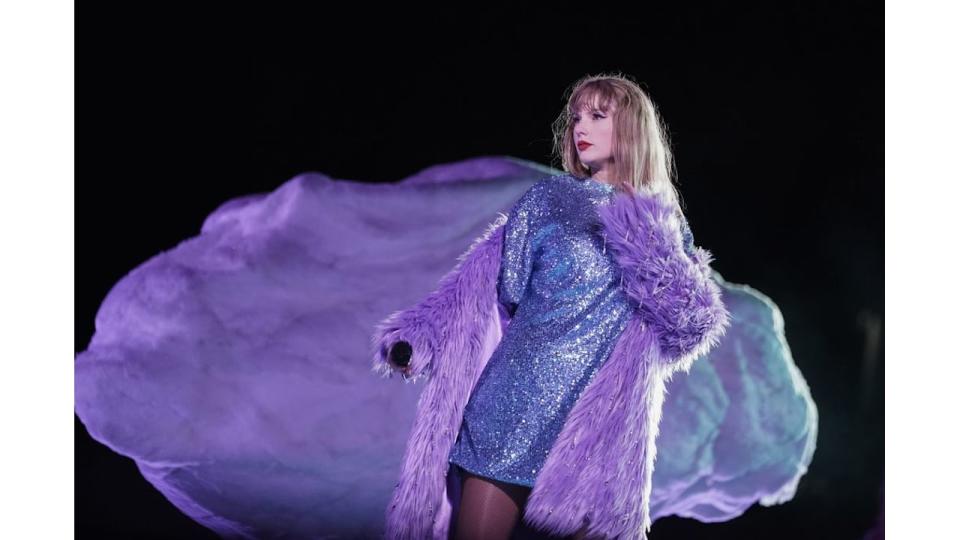 Taylor Swift on stage in purple