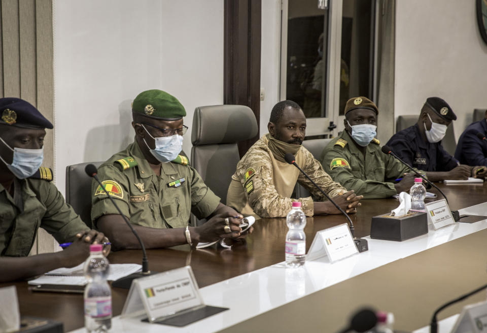Col. Assimi Goita, center, who has declared himself the leader of the National Committee for the Salvation of the People, is accompanied by group spokesman Ismael Wague, left, and group member Malick Diaw, center-left, as they meet with a high-level delegation from the West African regional bloc known as ECOWAS, at the Ministry of Defense in Bamako, Mali, Saturday, Aug. 22, 2020. Top West African officials are arriving in Mali's capital following a coup in the nation this week to meet with the junta leaders and the deposed president in efforts to negotiate a return to civilian rule. (AP Photo)