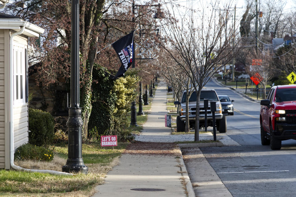 A home on the main road in Lovettsville, Va., displays the pro-Trump sentiments of its owners, on Dec. 16, 2021. The owners say their signs have been stolen several times and their flagpole snapped once. People on the left have had the same problem with their political and activist signs and flags. Political passions run deep in this Loudon County town. (AP Photo/Cal Woodward)