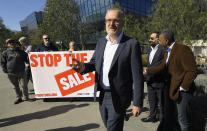 Maarten Botterman, center, chairman of the Internet Corporation for Assigned Names and Numbers, speaks before accepting a petition of more than 35,000 signatures and about 700 companies during a protest Friday, Jan. 24, 2020, in Los Angeles outside ICANN's headquarters which is the regulatory body for domain names. The company that controls the dot-org online universe is putting the registry of domain names up for sale, and the nonprofits that often use the suffix in their websites are raising concerns about the move. ICANN is meeting this weekend and is expected to rule by mid-February on plans by private-equity firm Ethos Capital to buy the Public Interest Registry for $1.1 billion. (AP Photo/Mark J. Terrill)