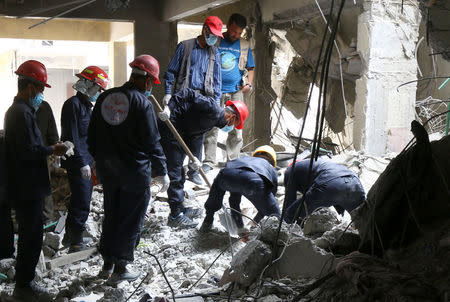 Rescue workers search for bodies still trapped under mounds of debris in Raqqa, Syria April 9, 2018. Picture taken April 9, 2018. REUTERS/Aboud Hamam