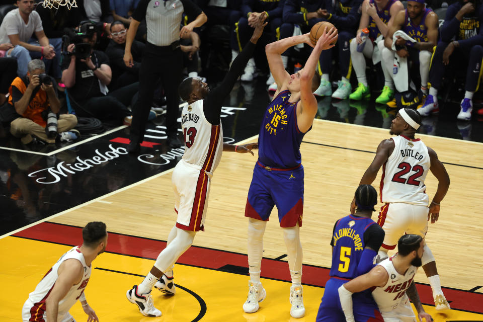 Nikola Jokic #15 of the Denver Nuggets shoots over Bam Adebayo #13 of the Miami Heat during the second quarter in Game Three of the 2023 NBA Finals at Kaseya Center on June 07, 2023 in Miami, Florida. NOTE TO USER: User expressly acknowledges and agrees that, by downloading and or using this photograph, User is consenting to the terms and conditions of the Getty Images License Agreement. (Photo by Megan Briggs/Getty Images)