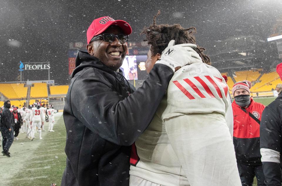 Aliquippa coach Mike Warfield hugs his players after winning Saturday's WPIAL Class 4A championship game at Heinz Field.