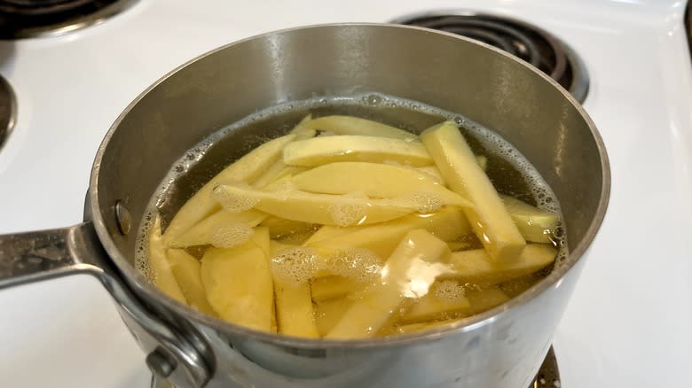 sliced rutabaga in pot of water