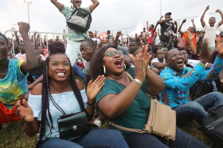 Mariama Doumbia celebrates with Anastasie Makon after Ivory Coast keeper Sylvain Gbohouo stopped a shot for a goal by Mali at the Africa Cup of Nations 2019 (Afcon), as they watch the game on screen in Abidjan