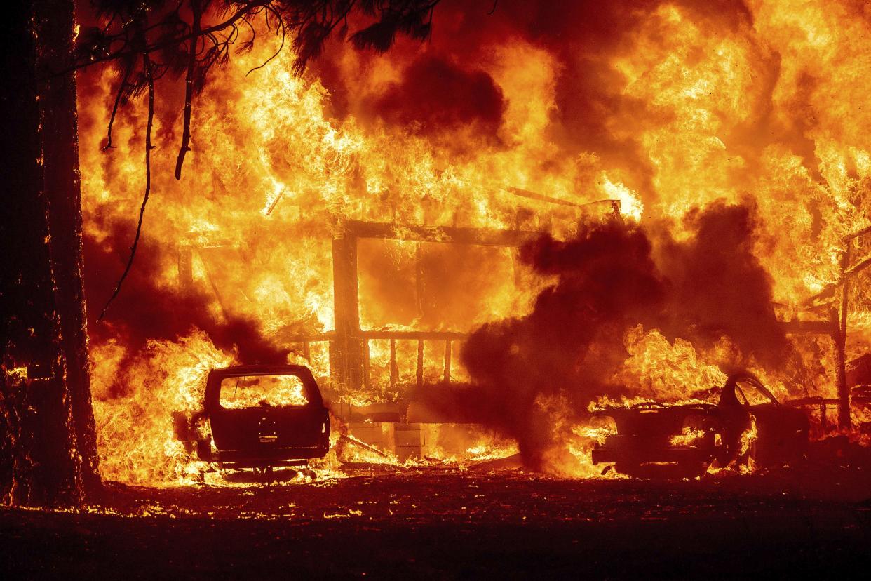 Flames consume a home on Highway 89 as the Dixie Fire tears through the Greenville community of Plumas County, Calif. on Wednesday, Aug. 4, 2021.