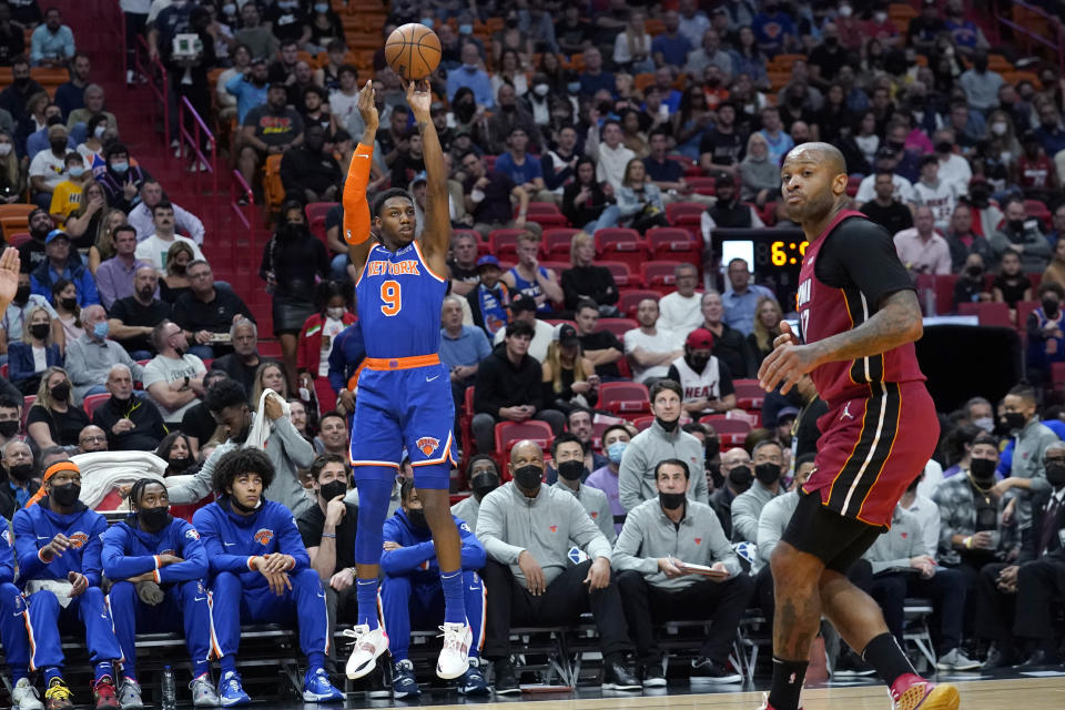 New York Knicks guard RJ Barrett (9) shoots a three-point basket over Miami Heat forward P.J. Tucker during the first half of an NBA basketball game, Wednesday, Jan. 26, 2022, in Miami. (AP Photo/Lynne Sladky)