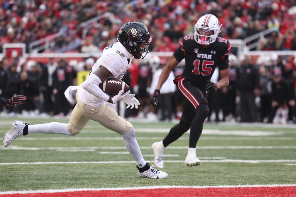 Colorado cornerback Travis Hunter scores a touchdown against Utah during the second half of an NCAA college football game, Saturday, Nov. 25, 2023, in Salt Lake City. (AP Photo/Rob Gray)