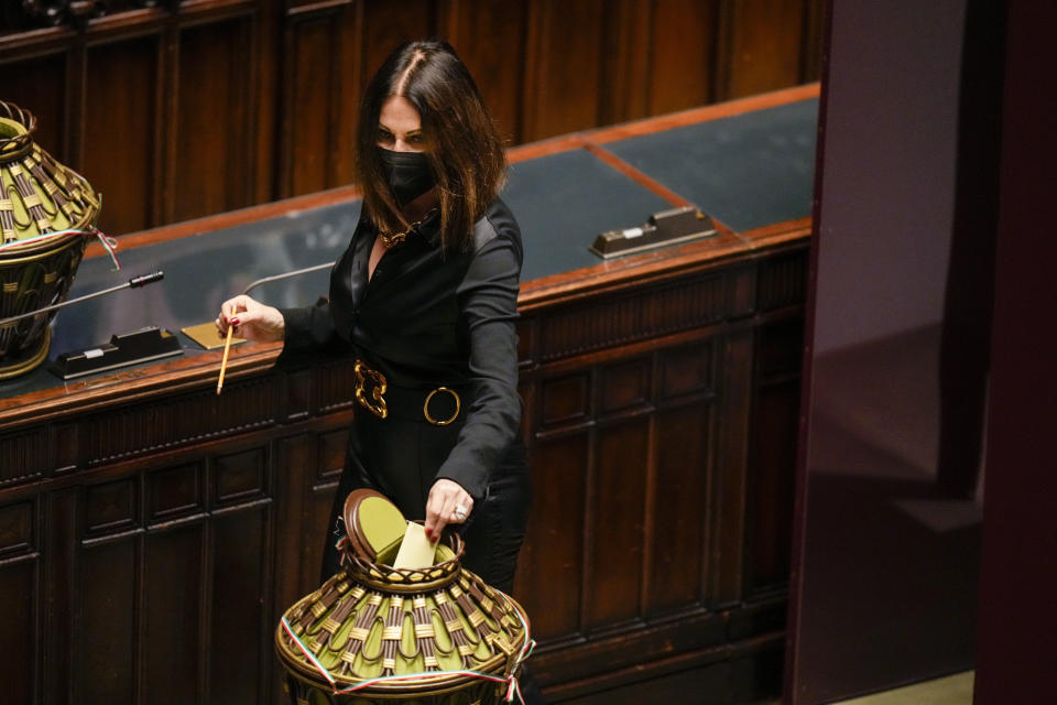 Senator Daniela Santanchè casts her ballot in the Italian parliament, in Rome, Tuesday, Jan. 25, 2022, during a voting session for the election of Italy's 13th president. A first round of voting in Italy's Parliament for the country's next president yielded an avalanche of blank ballots on Monday, as lawmakers and special regional electors failed to deliver a winner amid a political stalemate. (AP Photo/Alessandra Tarantino, pool)