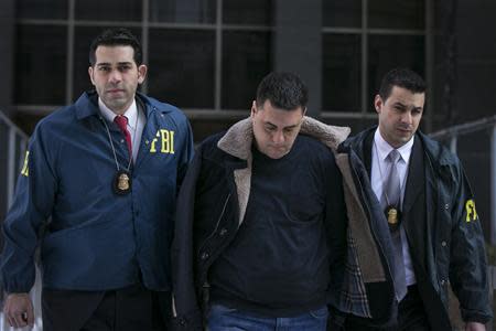 Gambino family associate Franco Lupoi (C) is escorted by FBI agents from their Manhattan offices in New York February 11, 2014. REUTERS/Brendan McDermid