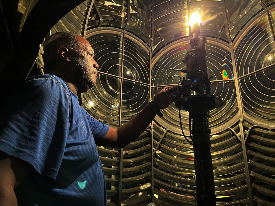 Jeffrey Forbes Jr. lighting the lantern at Elbow Reef lighthouse.