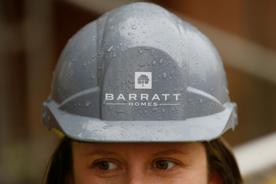 A Barratt employee wears a safety hat at a Barratt housing development near Haywards Heath, Britain, February 20, 2020. REUTERS/Peter Nicholls