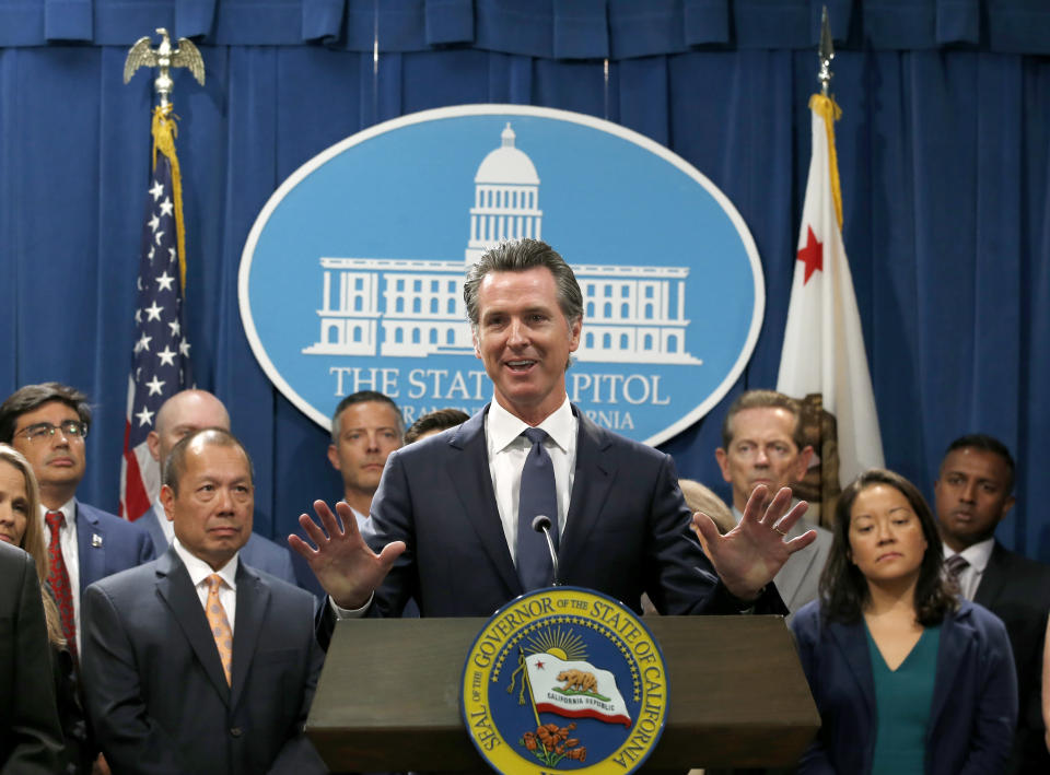 California Gov. Gavin Newsom, accompanied by a group of immigrant advocates and service providers, discusses the effects of the Trump administration's new rules blocking green cards for many immigrants who receive government assistance, during a news conference in Sacramento, Calif., Friday, Aug. 16, 2019. Newsom and Attorney General Xavier Becerra, announced that California has joined three other states and the District of Columbia in a lawsuit filed Friday against some of the administration's most aggressive moves to restrict legal immigration that are supposed to take effect in October. (AP Photo/Rich Pedroncelli)