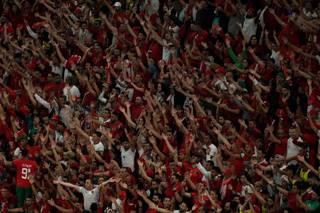 Moroccan fans cheer their team