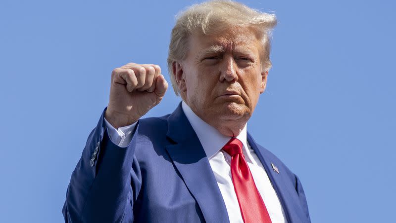 Former President Donald Trump gestures before boarding his personal plane at Miami International Airport, Tuesday, June 13, 2023, in Miami. Trump appeared in federal court Tuesday on dozens of felony charges accusing him of illegally hoarding classified documents and thwarting the Justice Department’s efforts to get the records back.