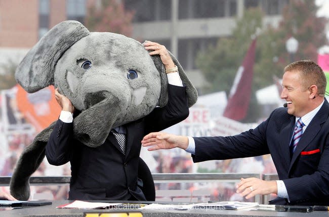 ESPN analyst Lee Corso shows his pick for Alabama vs. LSU football game as Kirk Herbstreit helps Corso put on an elephant head during ESPN's College Gameday show in front of Bryant-Denny Stadium Saturday, Nov. 9, 2013. (Michelle Lepianka Carter / The Tuscaloosa News)