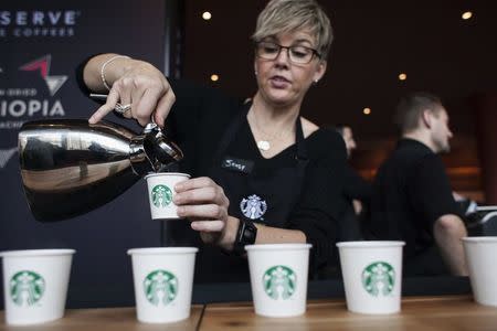 Sandy Roberts pours samples of Starbucks Reserve Sun Dried Ethiopia Yirgacheffe coffee during the company's annual shareholders meeting in Seattle, Washington, U.S. on March 19, 2014. REUTERS/David Ryder/File Photo