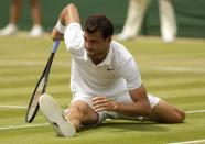 Grigor Dimitrov of Bulgaria slips during his match against Steve Johnson of the U.S.A. at the Wimbledon Tennis Championships in London, July 1, 2015. REUTERS/Henry Browne