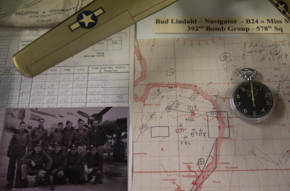 In this photo taken on Thursday, Nov. 7, 2019, a World War II model plane with navigation maps and a photograph are displayed at the Remember Museum 39-45 in Thimister-Clermont, Belgium. The museum houses countless World War II objects, but it's most important collection are stories and photos of those who served in World War II, mostly during the Battle of the Bulge. Veterans of the WWII Battle of the Bulge are heading back to mark, perhaps the greatest battle in U.S. military history, when 75-years ago Hitler launched a desperate attack deep through the front lines in Belgium and Luxembourg to be thwarted by U.S. forces. (AP Photo/Virginia Mayo)