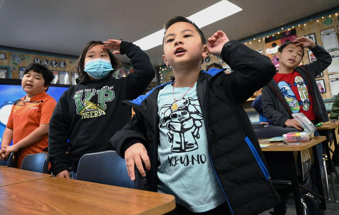 Keyno Yang, right, and other third-grade students take turns singing songs in Hmong and English in Fresno Unified’s Hmong Dual Immersion program at Vang Pao Elementary Thursday, Feb. 23, 2023 in Fresno.
