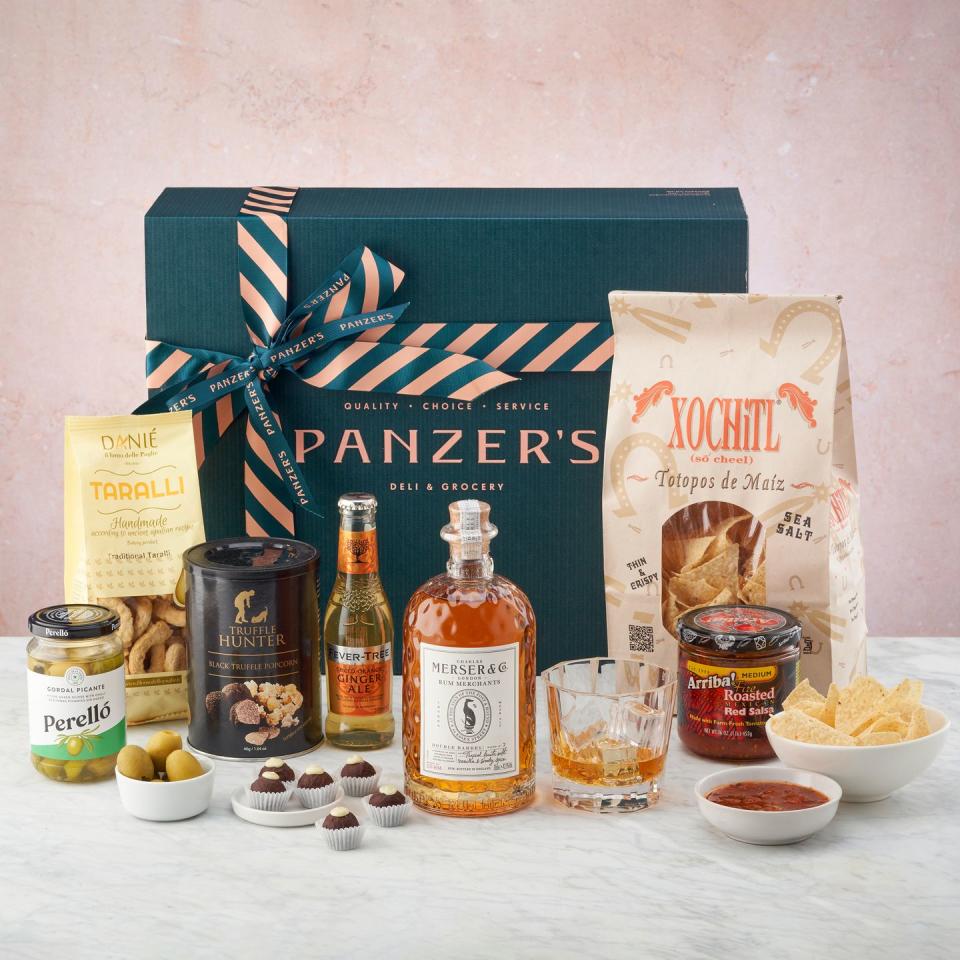 <p>Featuring a bottle of smooth Merser rum, a glass and a selection of delicious snacks from the famous London deli.</p><p><a class="link " href="https://panzers.co.uk/hampers/marvellous-merser/" rel="nofollow noopener" target="_blank" data-ylk="slk:BUY NOW;elm:context_link;itc:0;sec:content-canvas">BUY NOW</a> £89, Panzers </p>