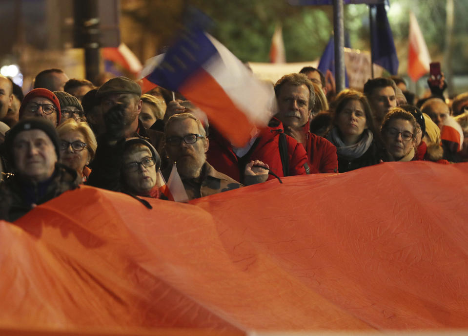 Demonstrators hold a rally to protest against changes to Poland's judiciary planned by the ruling Law and Justice party near the building of parliament in Warsaw, Poland, Wednesday, Dec. 18, 2019. (AP Photo/Czarek Sokolowski)