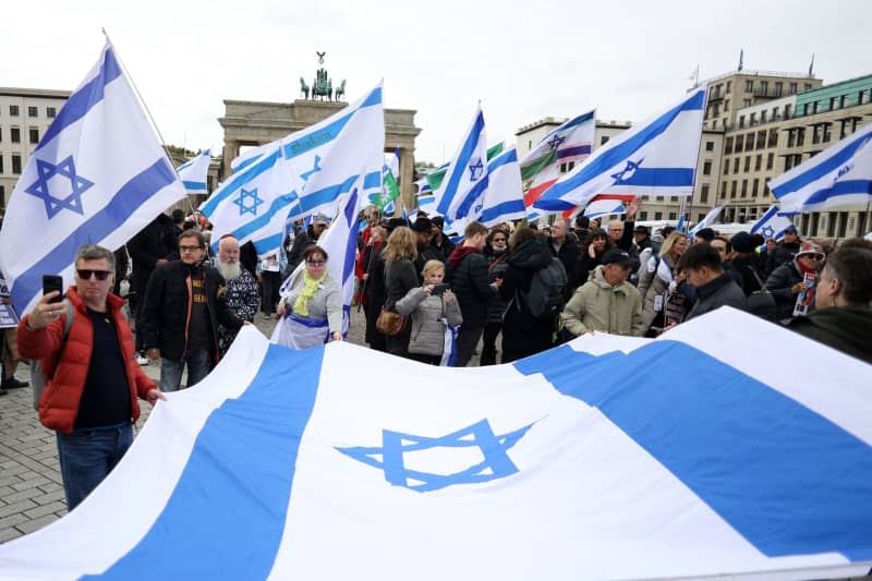 People take part in a pro-Israel protest under the motto 'Together Against Hamas' Crimes Against Israelis and Palestinians,' marking the first anniversary of the October 7 attacks on Israel. Joerg Carstensen/dpa