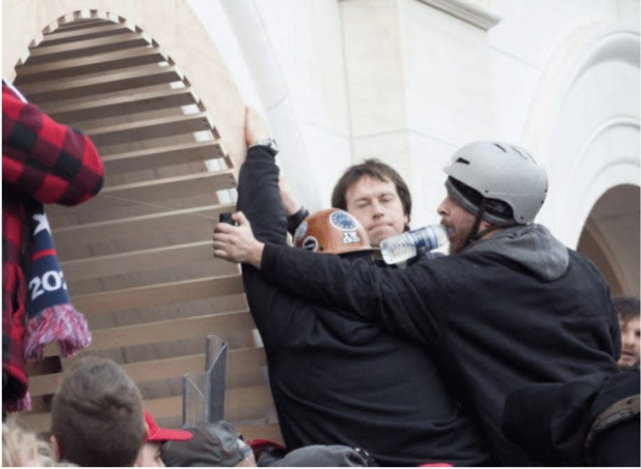 Cody Mattice spraying a chemical agent at the Capitol riot last year.